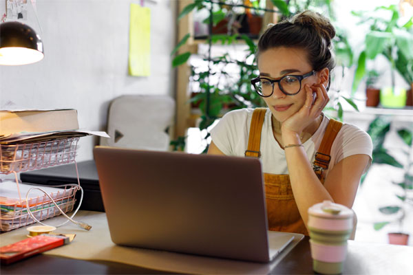 Photo of young woman working on her laptop