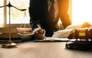 image of a person signing in a law firm