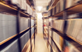 Blurred image of an archive with shelves of documents