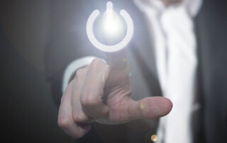 Image of a person touching the icon of a power button.